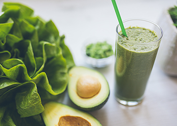 Avocado and spinach smoothie in a glass