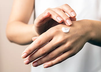 Woman applying hand cream