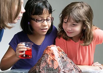 Three friends doing a volcano science project