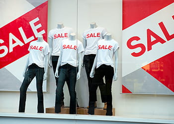 Mannequins in shop window promoting a sale