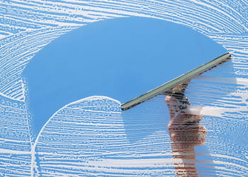 Window being cleaned with a squeegee
