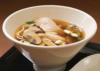 Chicken noodle soup in white bowl