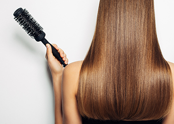Woman from behind with long, brown shiny hair
