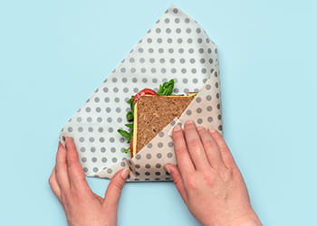 Sandwich being wrapped in a beeswax wrap
