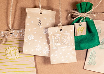 small-gift-bags-tied-to-string-for-advent-calendar