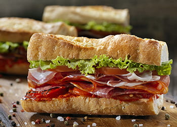 baguette filled with cold meat and salad