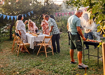 Group of friends having a garden BBQ party