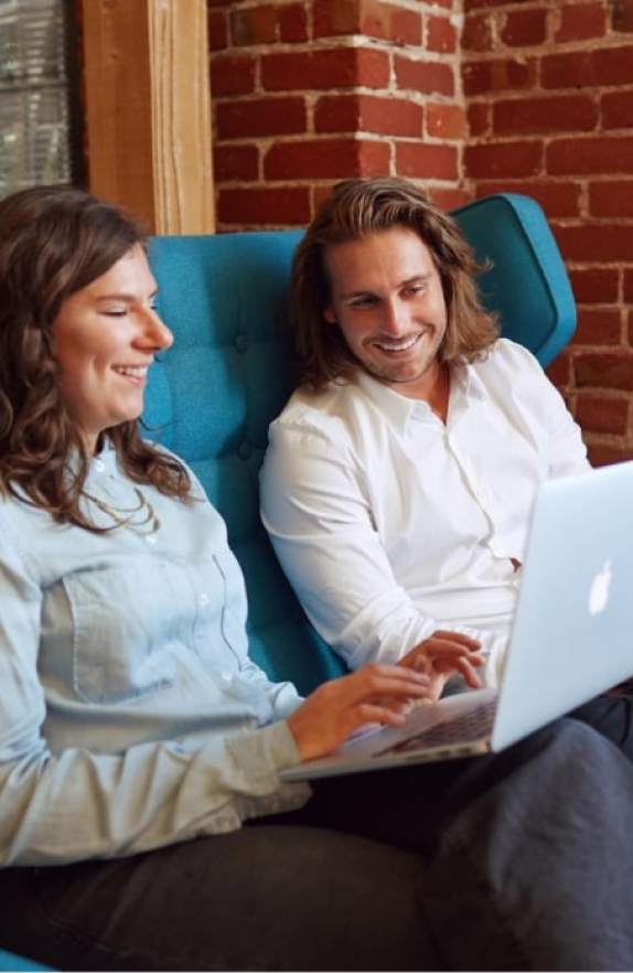 Two people collaborating on laptop