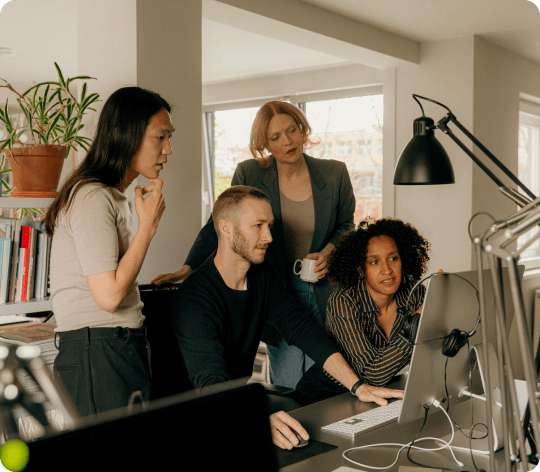 Multiple workers looking at one computer