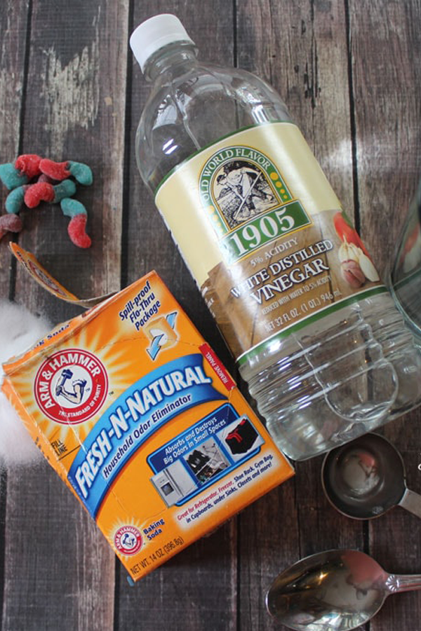 A box of baking soda with a bottle of vinegar.