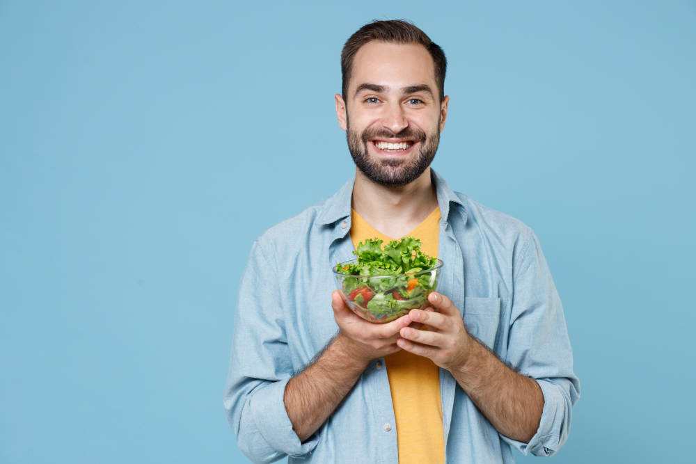 man holding a salad