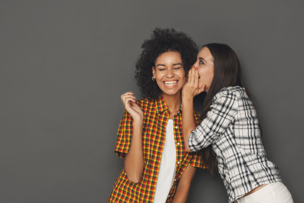 Women whispering to each other