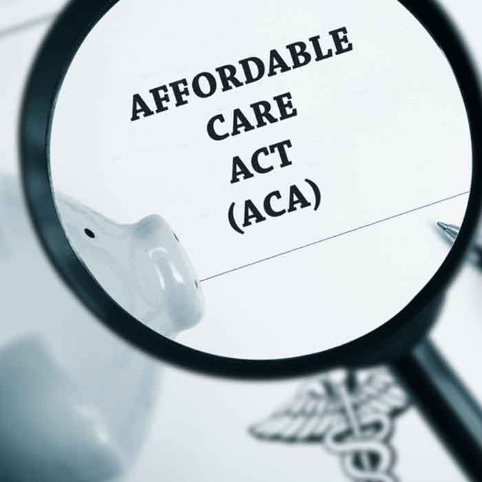 Magnifying glass with the text affordable care act (ACA)