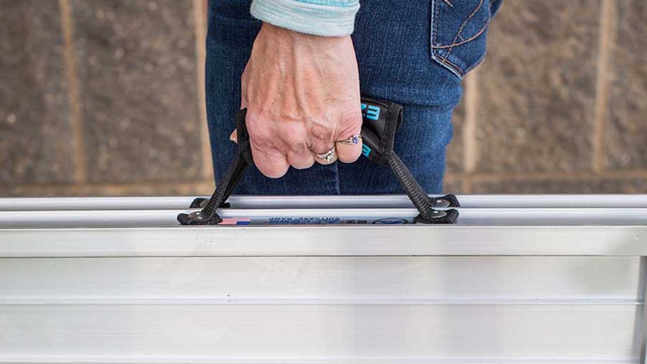 photo of SUITCASE® Singlefold AS Ramp being carried by using the ergonomic handles
