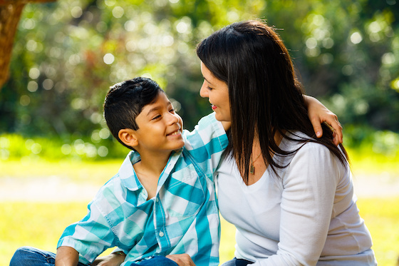A mother and son embracing.