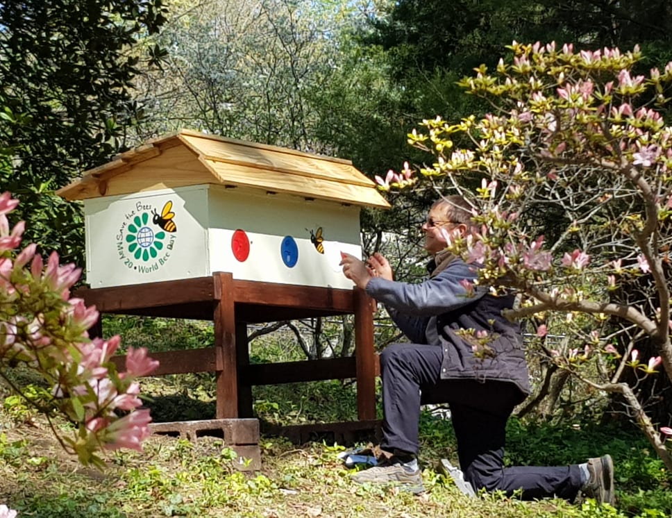 Peter Pešec, husband of Slovenian defense attaché Mojca Pešec, tends bees in the hives they built on their property. Photo credit: Mojca Pešec