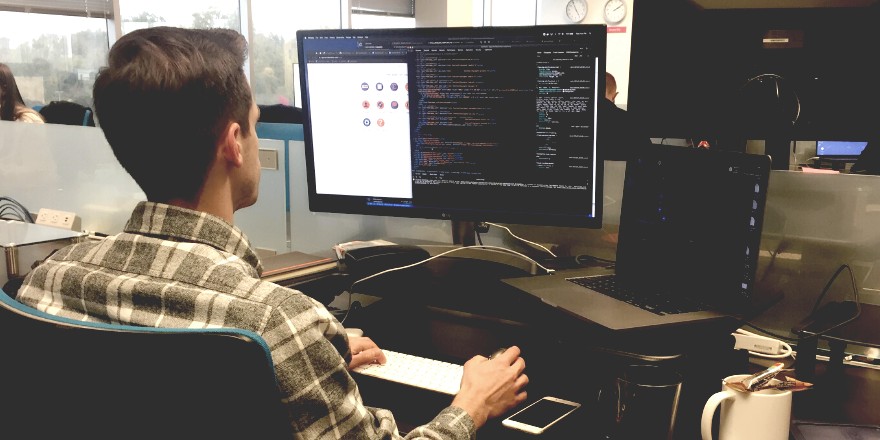 Laborchart's director of engineer behind a computer screen typing code.