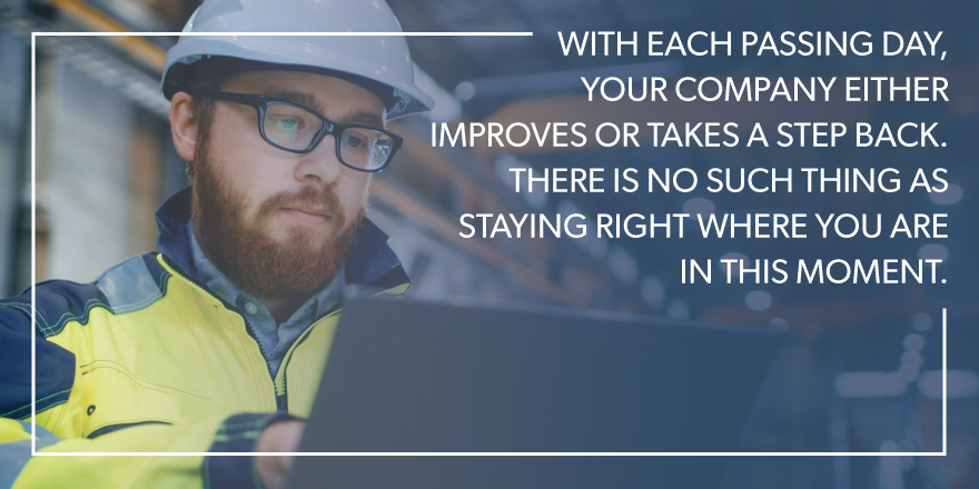 A man on his computer with text stating "with each passing day, your company either improves or takes a step back. there is no such thing as staying right where you are in this moment." over the image.