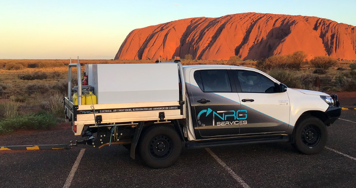 A NRG Services electrical contracting van in front of Australia mountains.