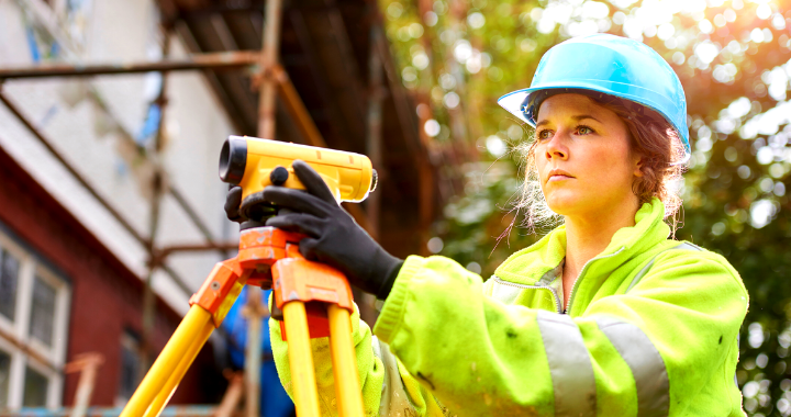 A woman construction field engineer with a futuristic look in her eye.