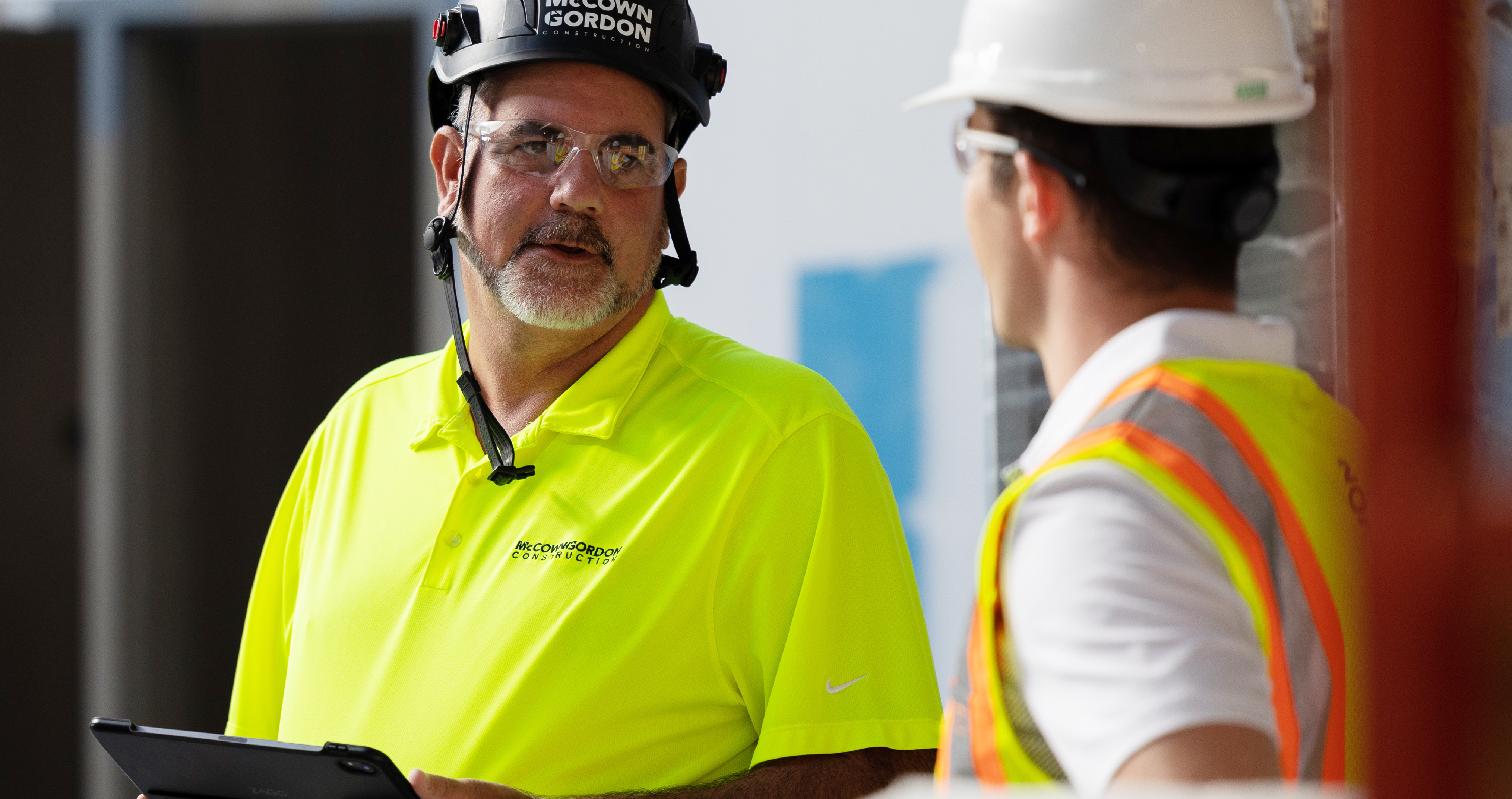 A superintendent discusses his rostering plans with a worker.