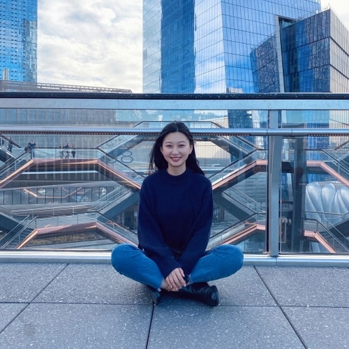 A photo of me, I sits on the top floor of The Vessel with a big smile.