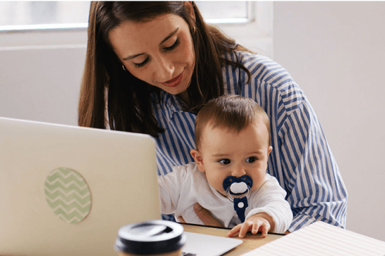 mom with a baby on computer