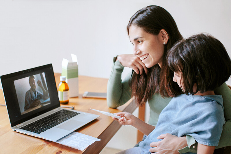 mom and kid in a call with dad
