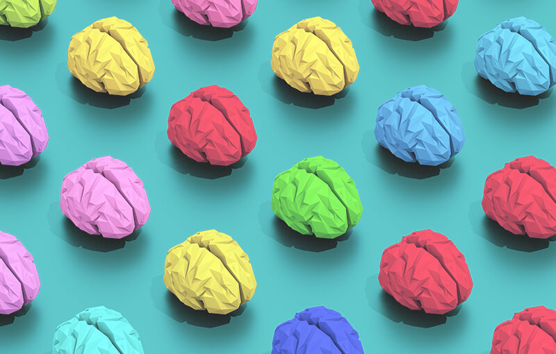Repeating pattern of multicolored brains on a light blue background.