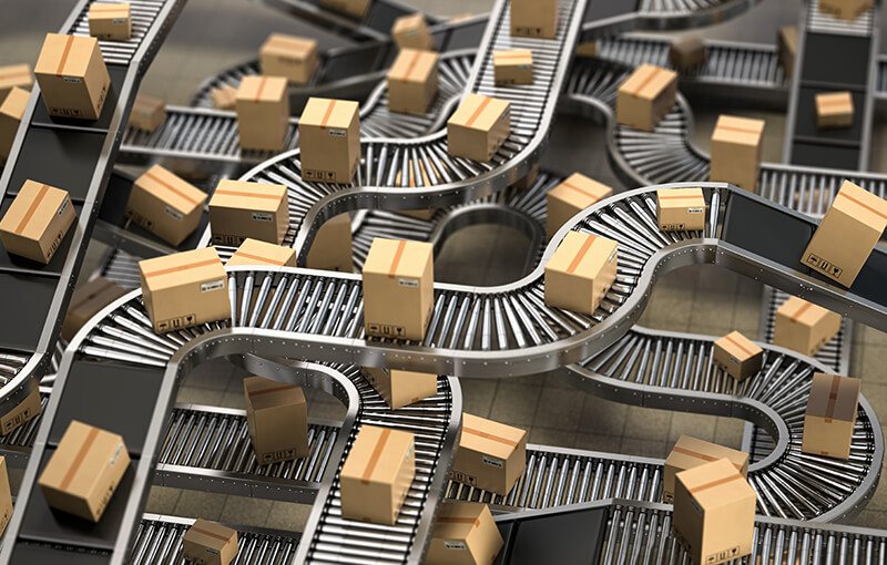 Many cardboard box packages on winding conveyor belts and rollers.