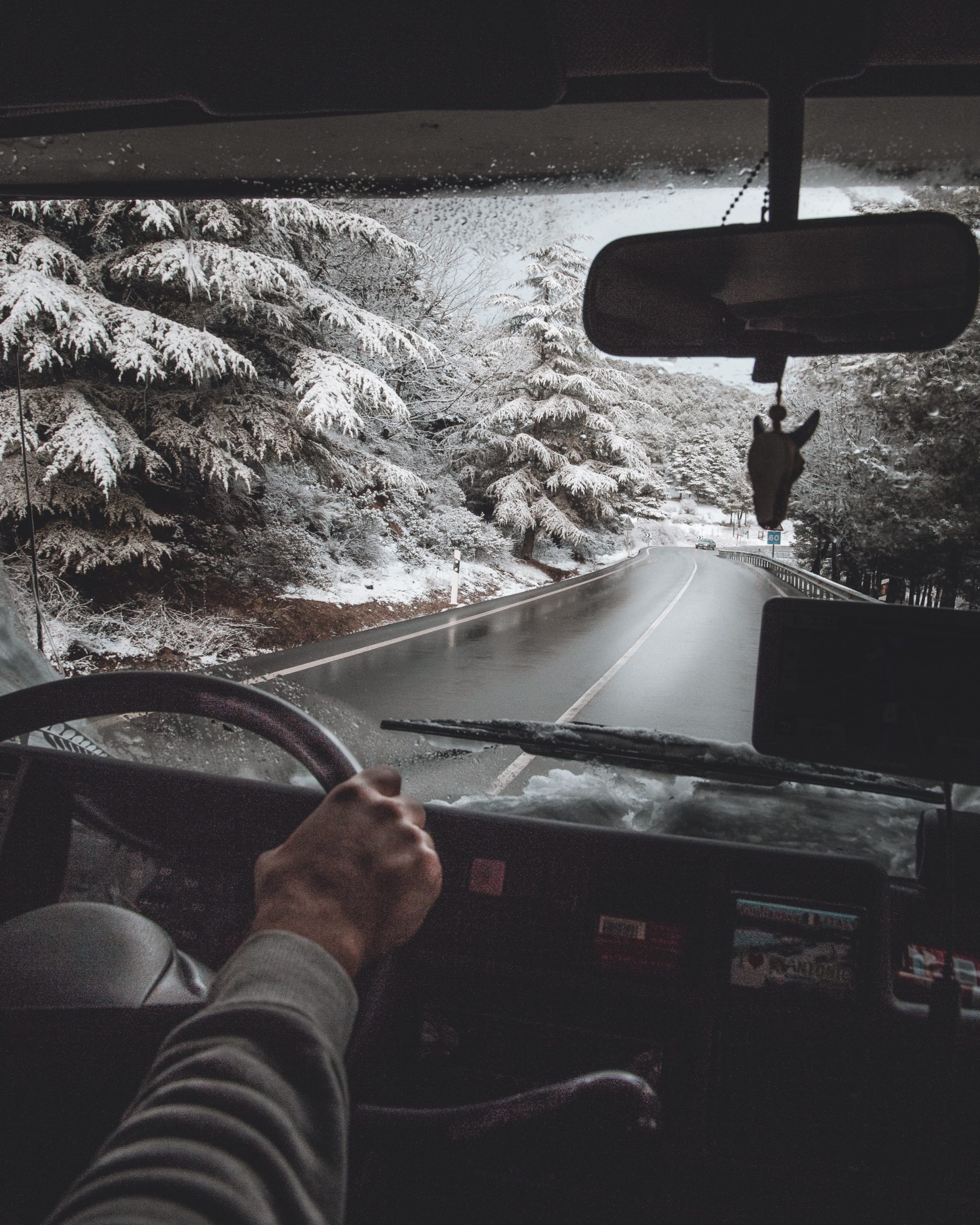 Behind the wheel of a driver navigating winter roads
