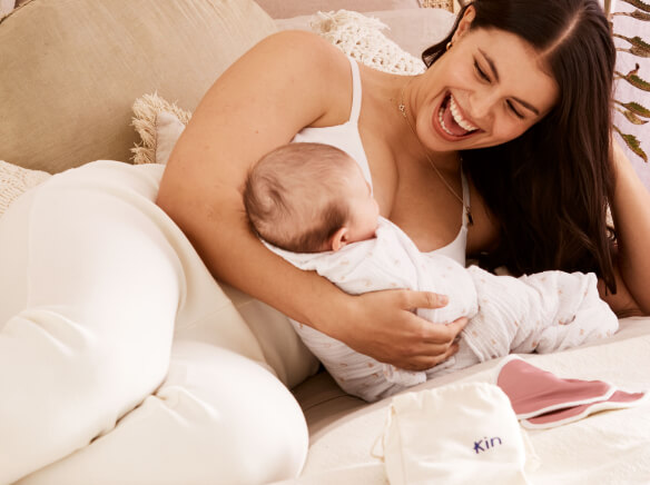 a woman laying with a baby