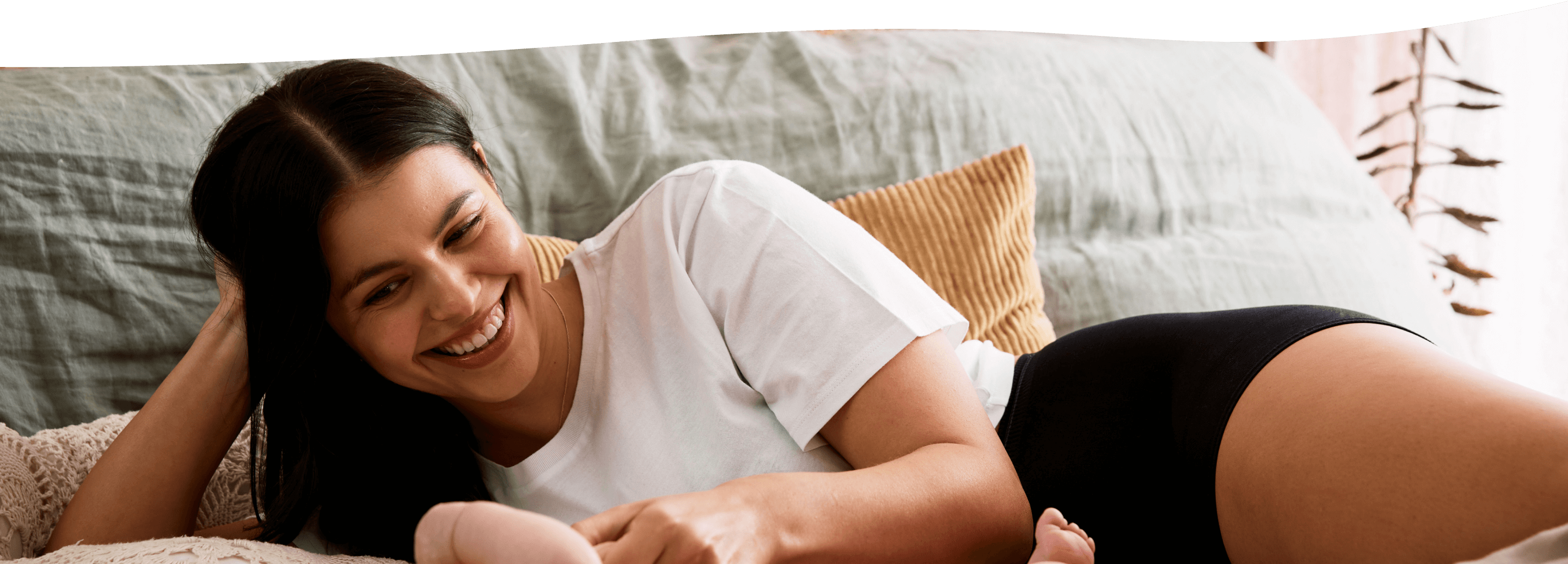 a woman laying with a baby