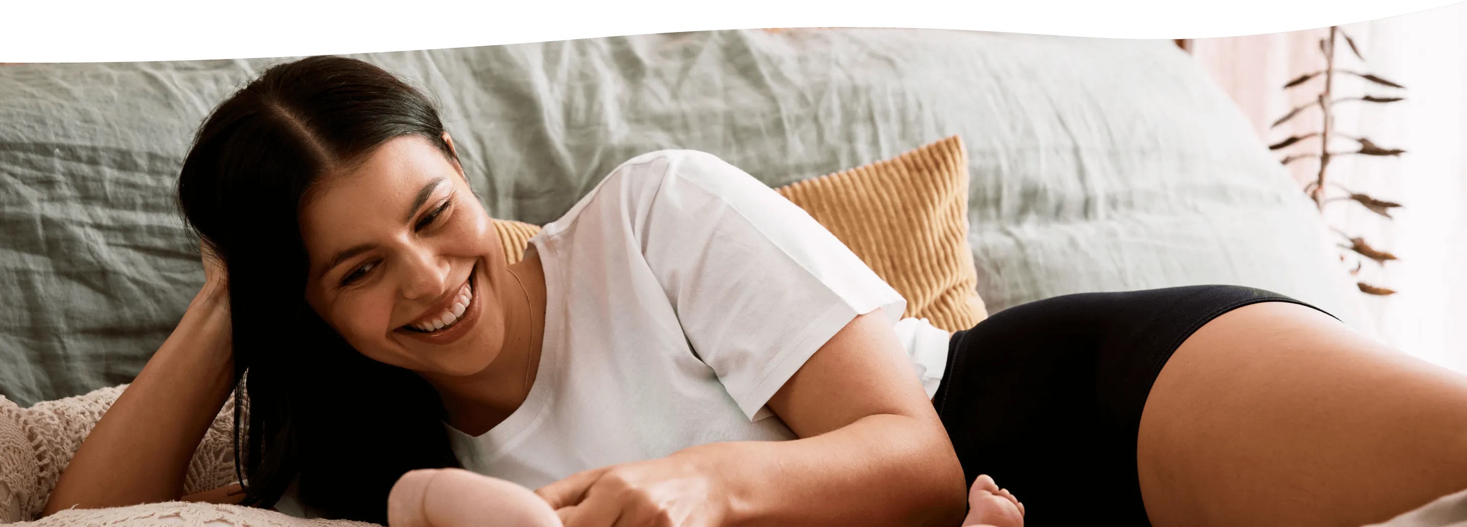 a woman laying with a baby