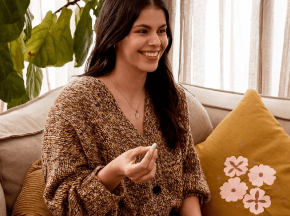 a woman taking a pill
