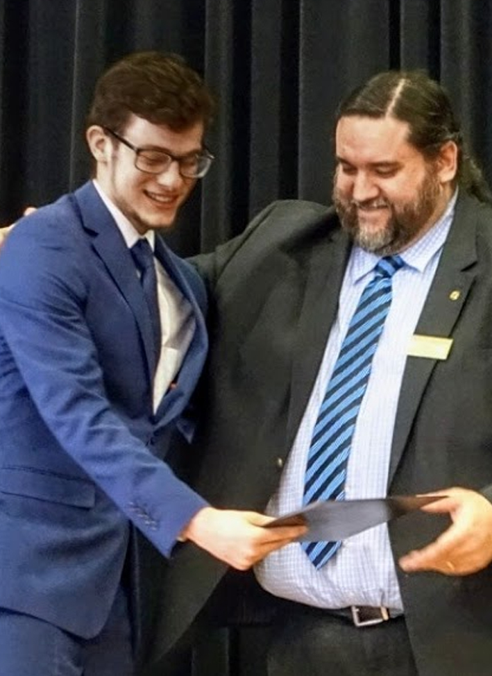 Matthew receiving a certificate