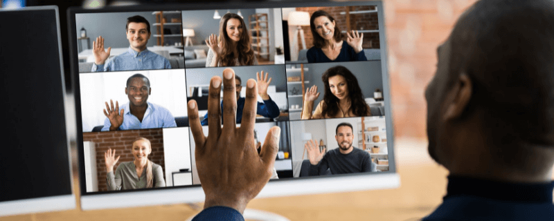 Man attends virtual conference at computer