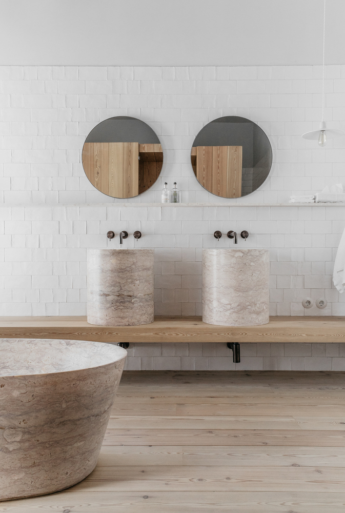 Subway tiles in bathroom with minimal contemporary design round mirror