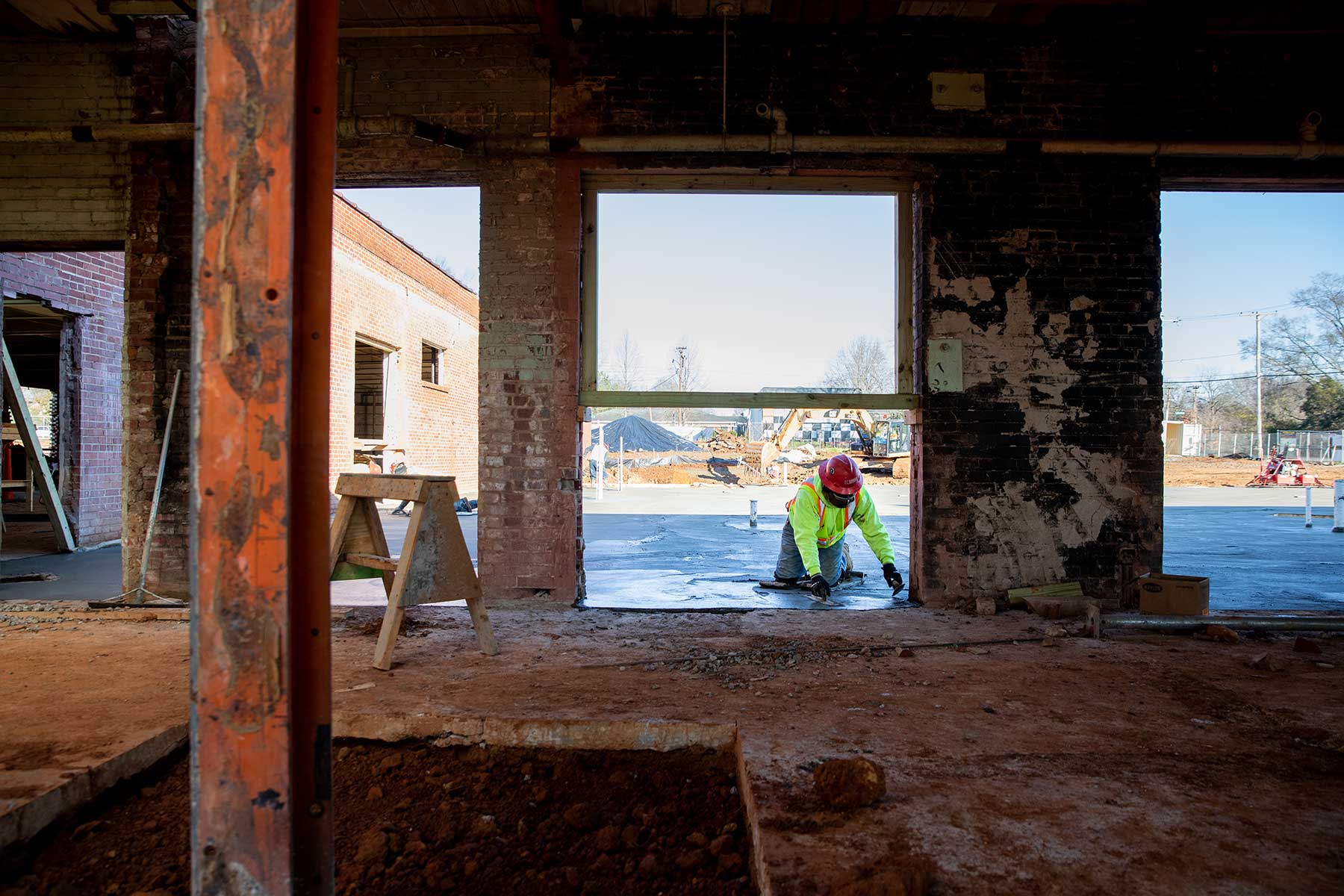 Construction Worker Laying Down Cement