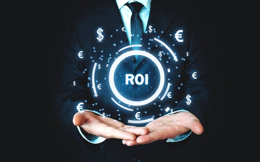 Image of man in a suit, holding a globe that says "ROI"