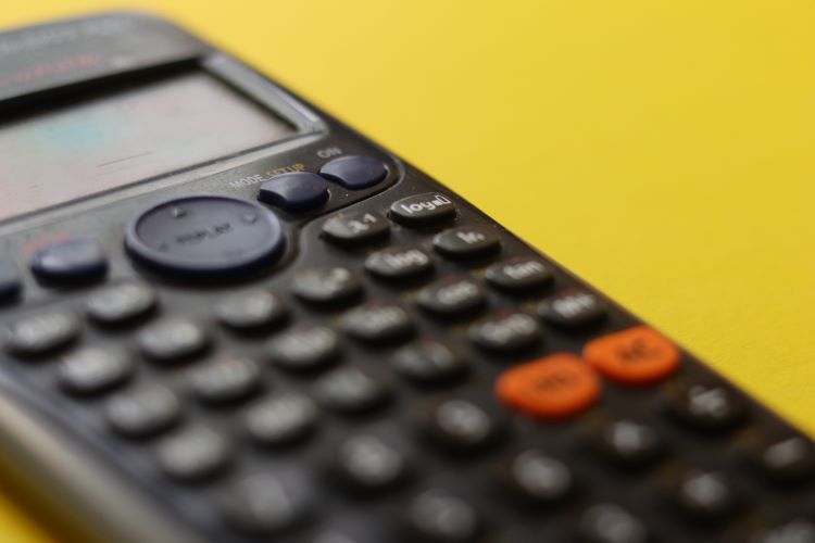 Image of an accounting calculator against a yellow background.