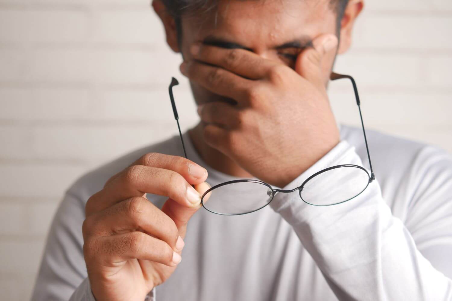 Image of man looking frustrated, rubbing his temples.