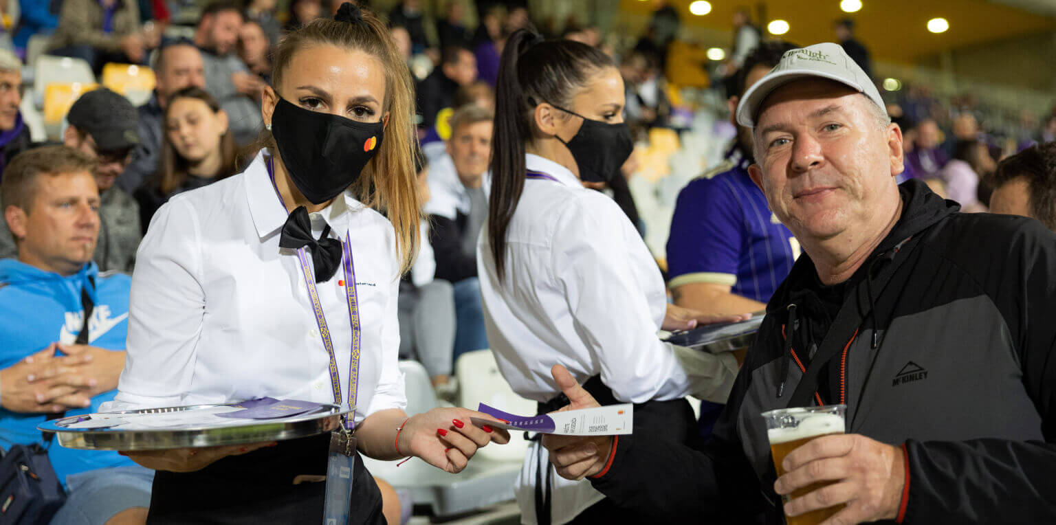 Football fan handed menu with QR code for ordering