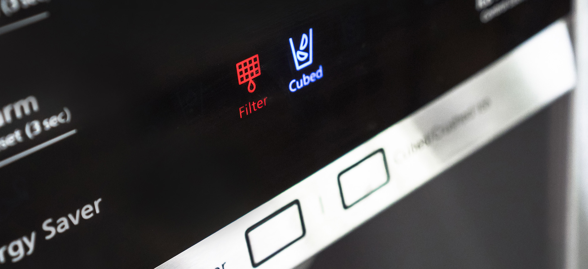 How do I reset the water filter indicator light on my refrigerator?