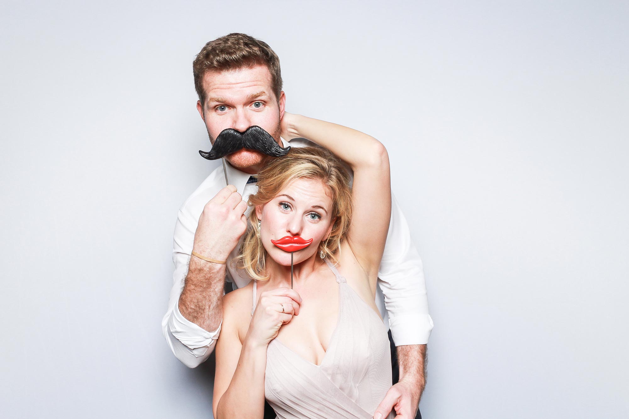 Fake mustache photo booth pose