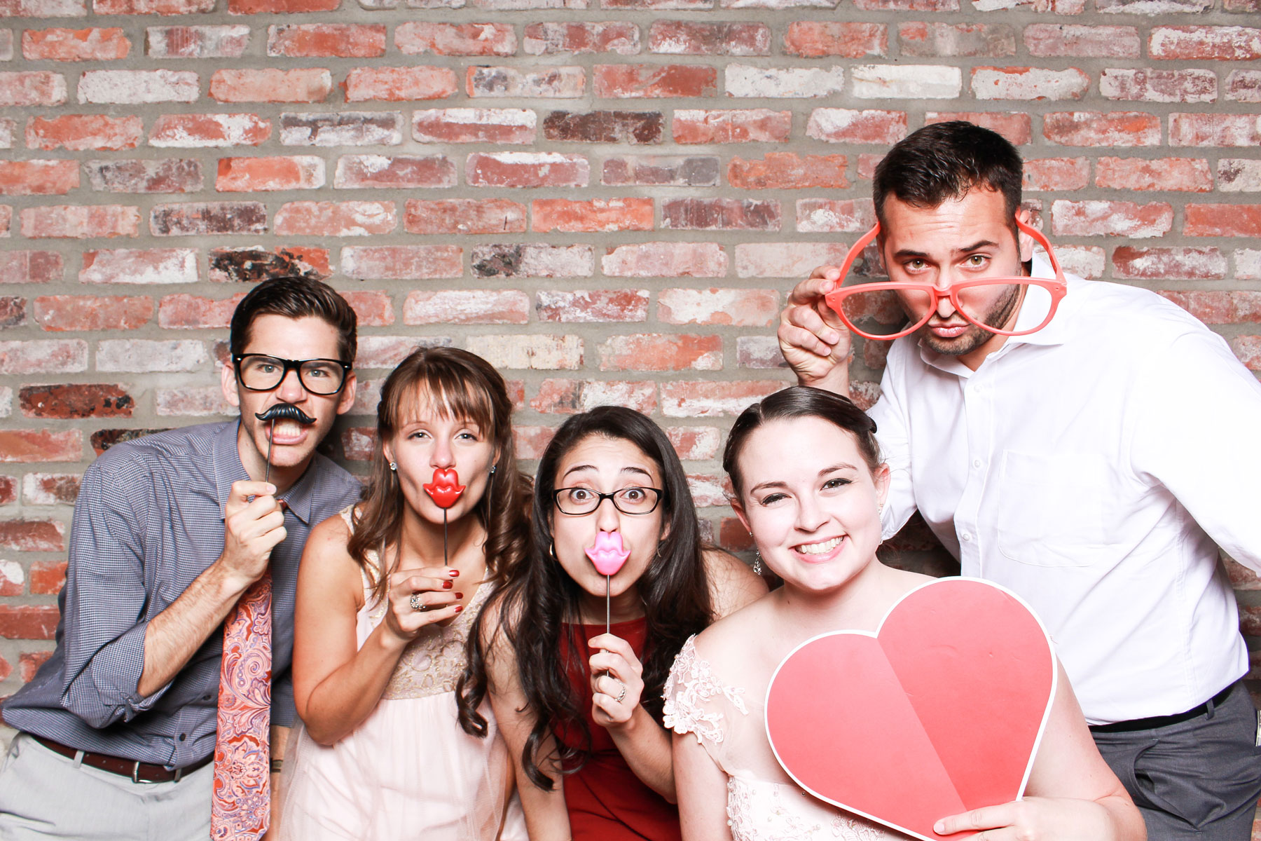 Open air photo booth brick backdrop
