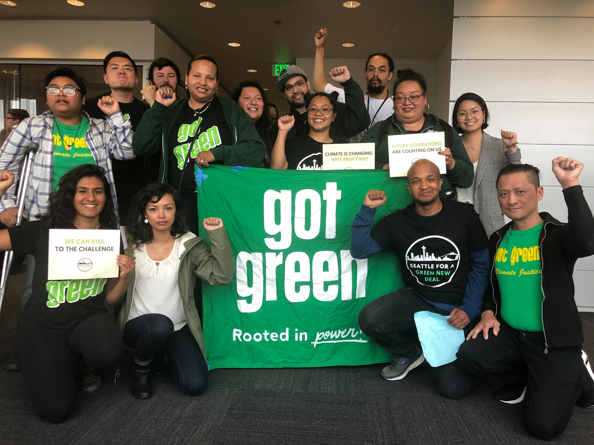 Group of people in front of a sign saying "Got Green"