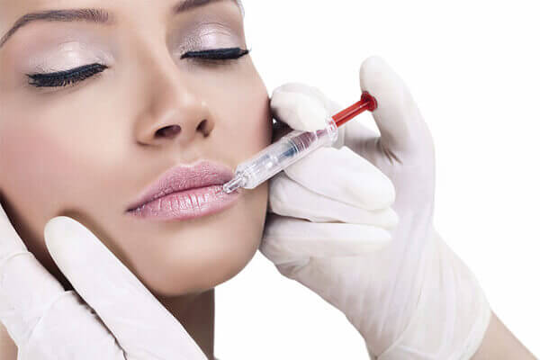 Woman receiving a lip injection