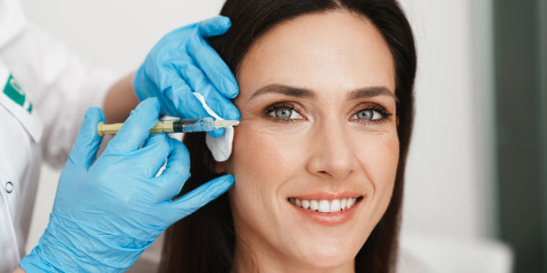 Woman getting a Botox injection in her face