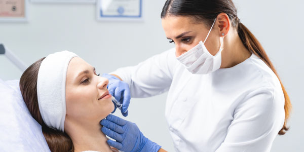 Woman receiving dermal filler injection